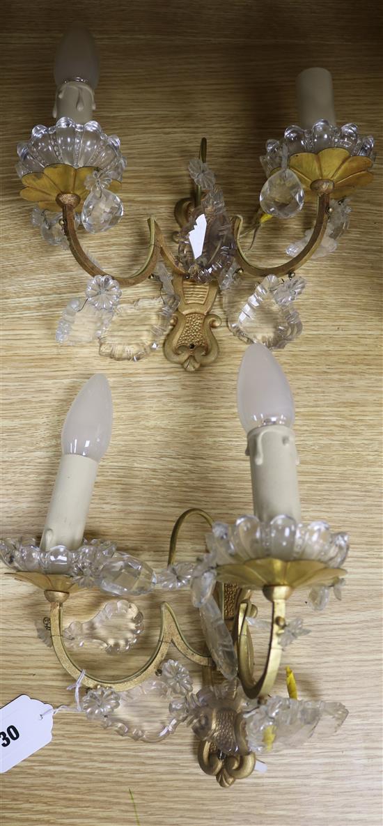 A pair of French gilt and cut glass wall lights